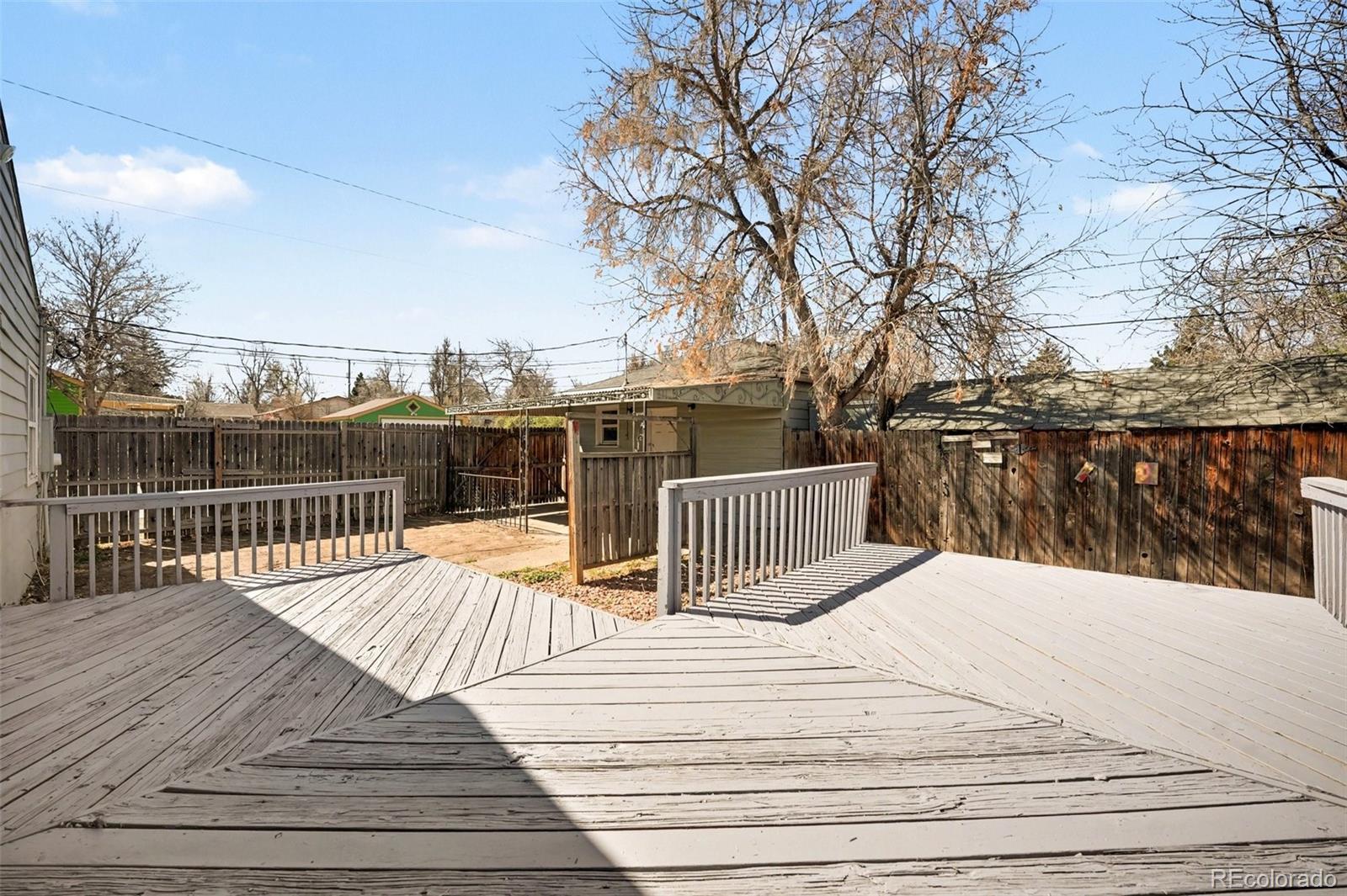 1701 Ironton Street Aurora, CO 80010 - Photo 18 of 23 a view of deck with wooden floor and fence with plants