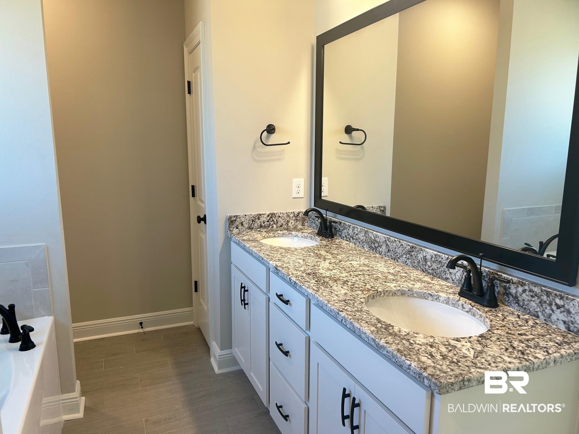 881 Sumter Loop Foley, AL 36535 - Photo 7 of 19 Bathroom with a bath, hardwood / wood-style floors, and vanity