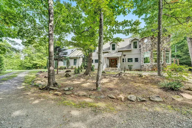 front view of a house with a tree