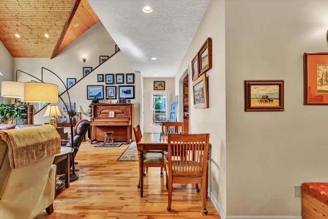 a living room with stainless steel appliances kitchen island granite countertop furniture a rug and a kitchen view
