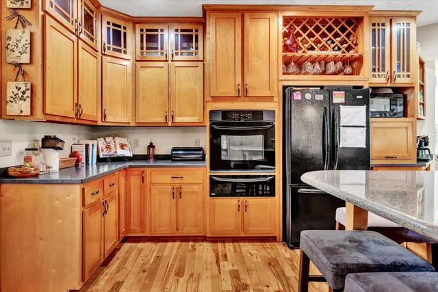 a kitchen with stainless steel appliances granite countertop a stove and a refrigerator