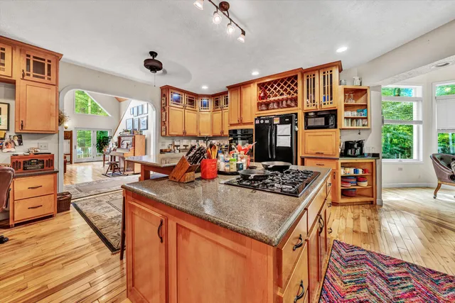 a kitchen with stainless steel appliances granite countertop a stove and a refrigerator