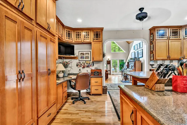 a kitchen with stainless steel appliances granite countertop a sink stove and wooden cabinets