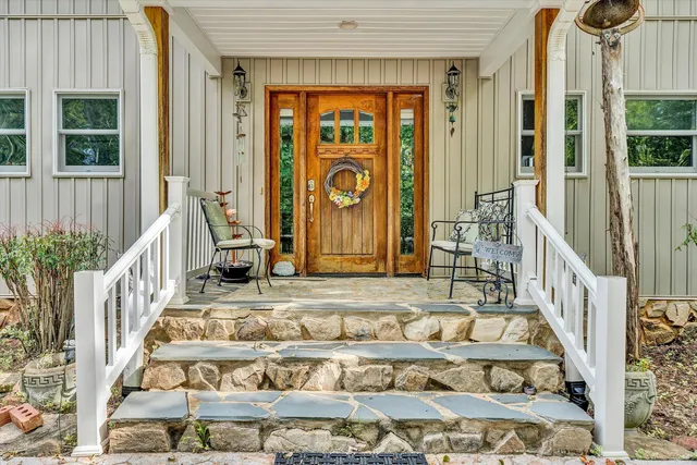 a view of an entryway with wooden floor