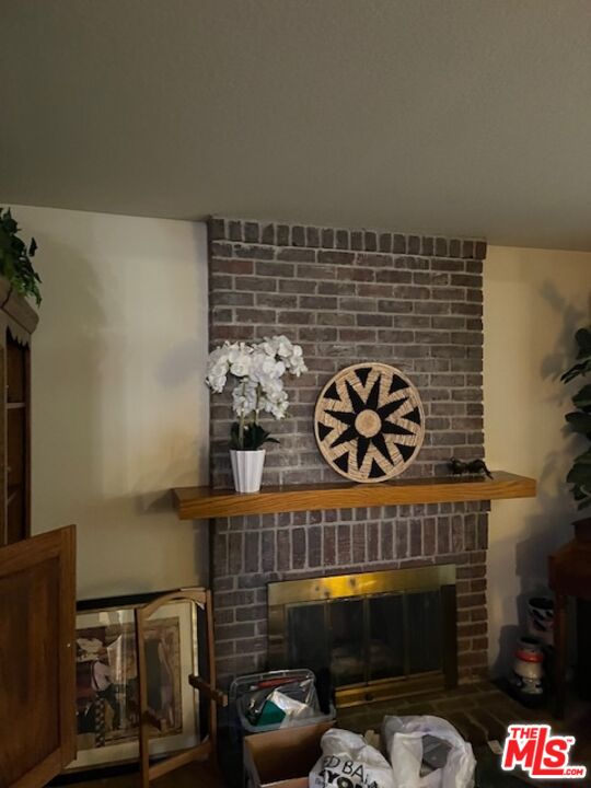 5259 West Goldenwood Drive Inglewood, CA 90302 - Photo 3 of 9 a living room with furniture a rug and a fireplace