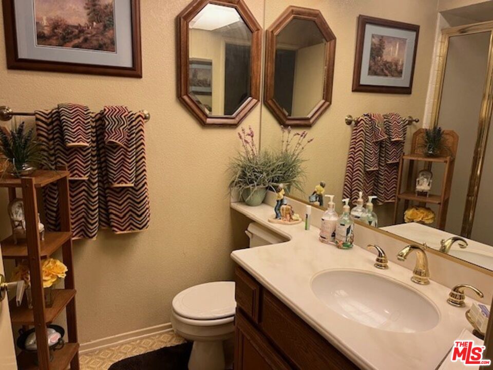 5259 West Goldenwood Drive Inglewood, CA 90302 - Photo 9 of 9 a bathroom with a toilet sink and mirror