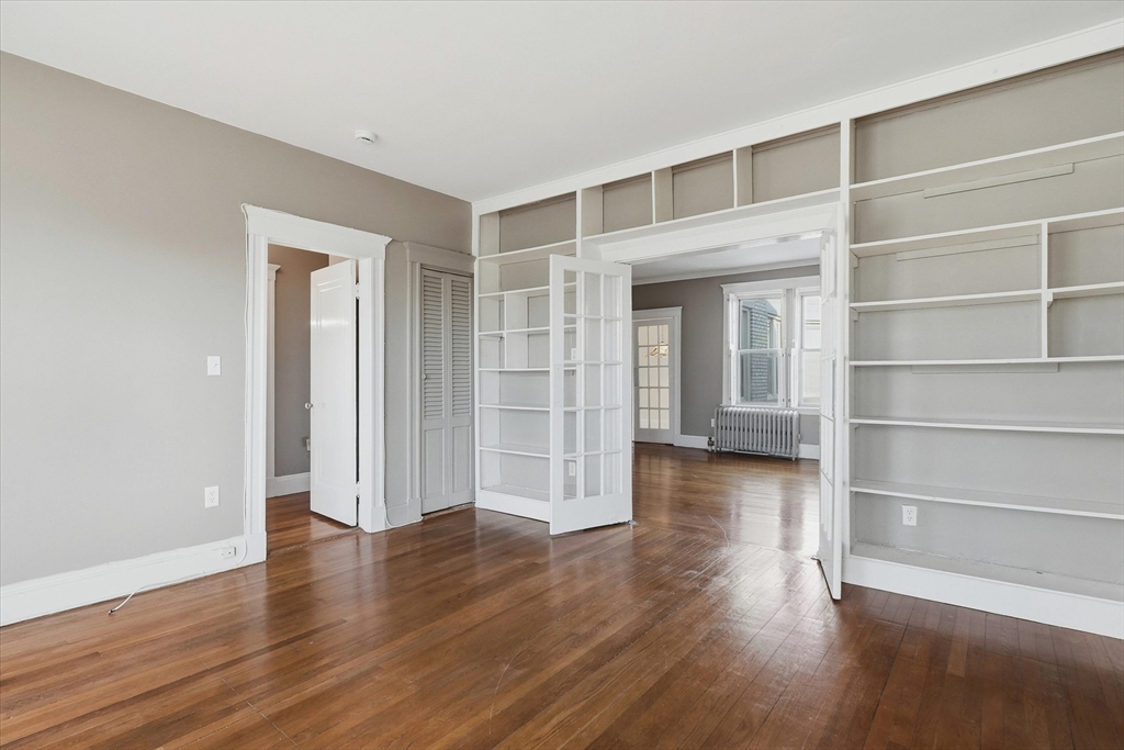 70 Fenway, Unit 51 Boston, MA 02115 - Photo 16 of 24 a view of an empty room with wooden floor and a window