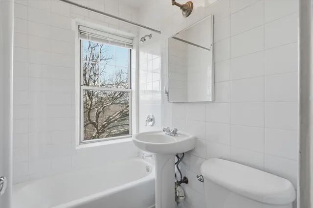 a bedroom with bed and window