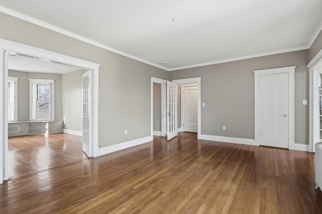 70 Fenway, Unit 51 Boston, MA 02115 - Photo 8 of 24 a view of an empty room with wooden floor
