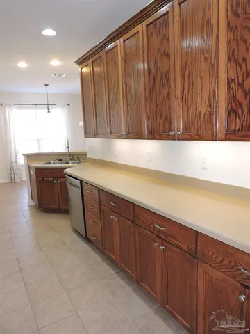 a kitchen with stainless steel appliances granite countertop wooden cabinets a sink and dishwasher