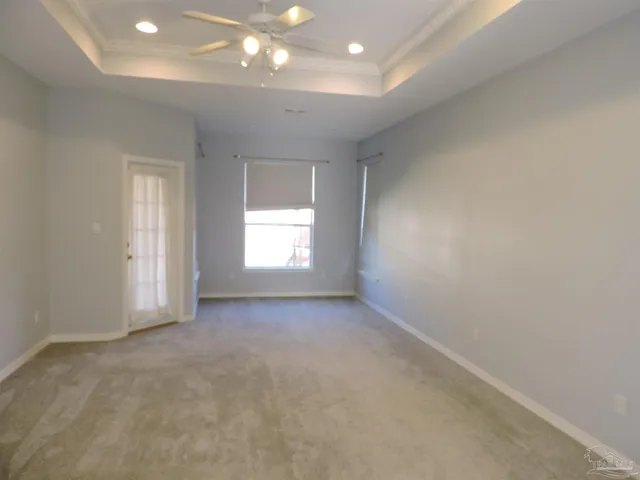 an empty room with windows and closet