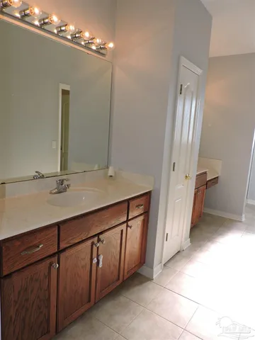 a bathroom with a double vanity sink a and mirror