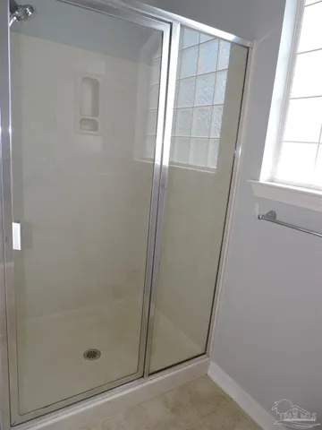 a bathroom with a glass door shower