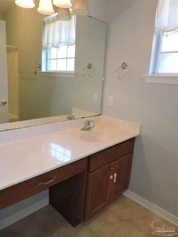 a bathroom with a sink vanity and a mirror