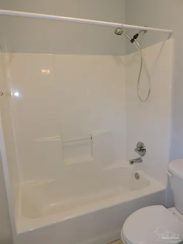 a bathroom with a shower and a toilet