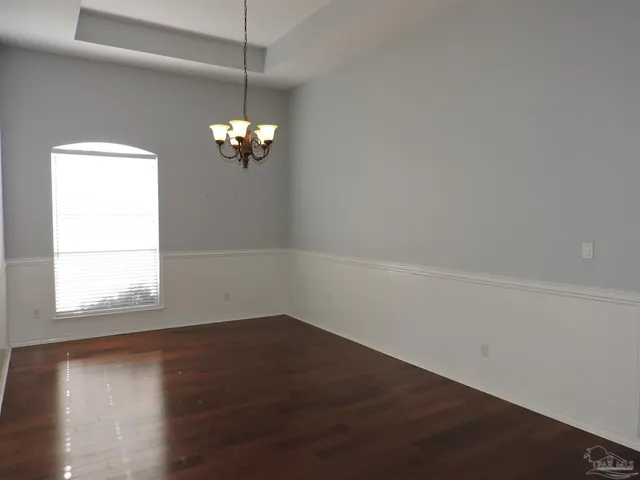 a view of a room with wooden floor and a window