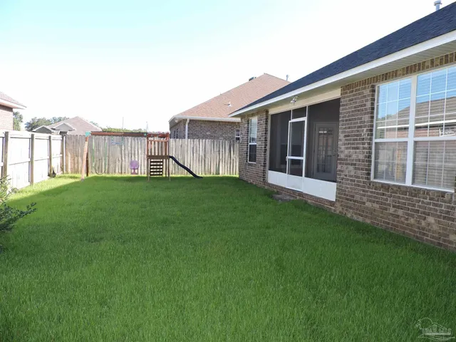 a view of a house with a yard and deck