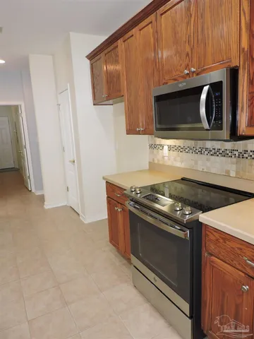 a stove top oven sitting inside of a kitchen