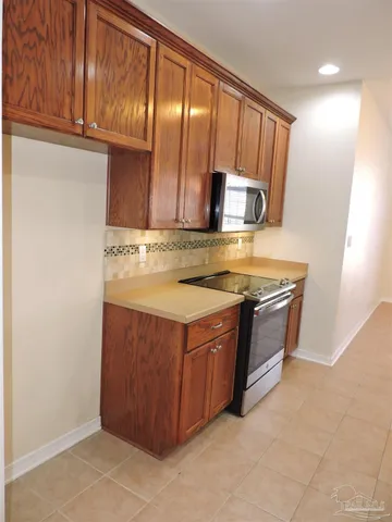 a kitchen with stainless steel appliances granite countertop a sink and a stove