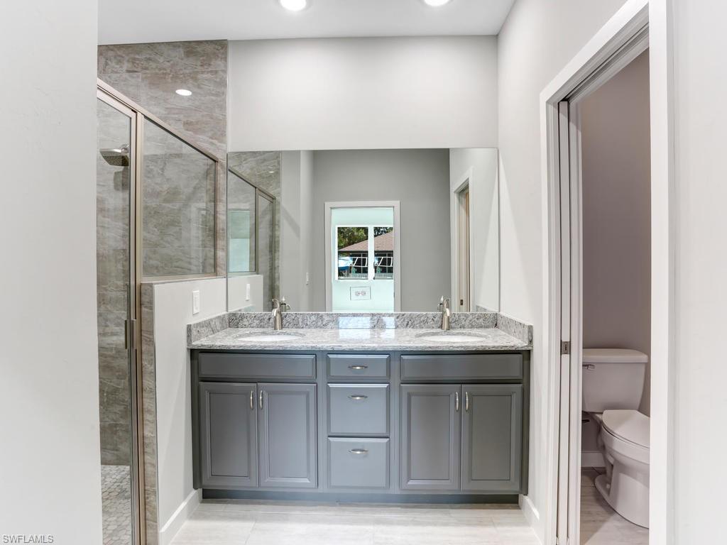 17385 Connecticut Road Fort Myers, FL 33967 - Photo 25 of 31 a bathroom with a granite countertop sink and a mirror