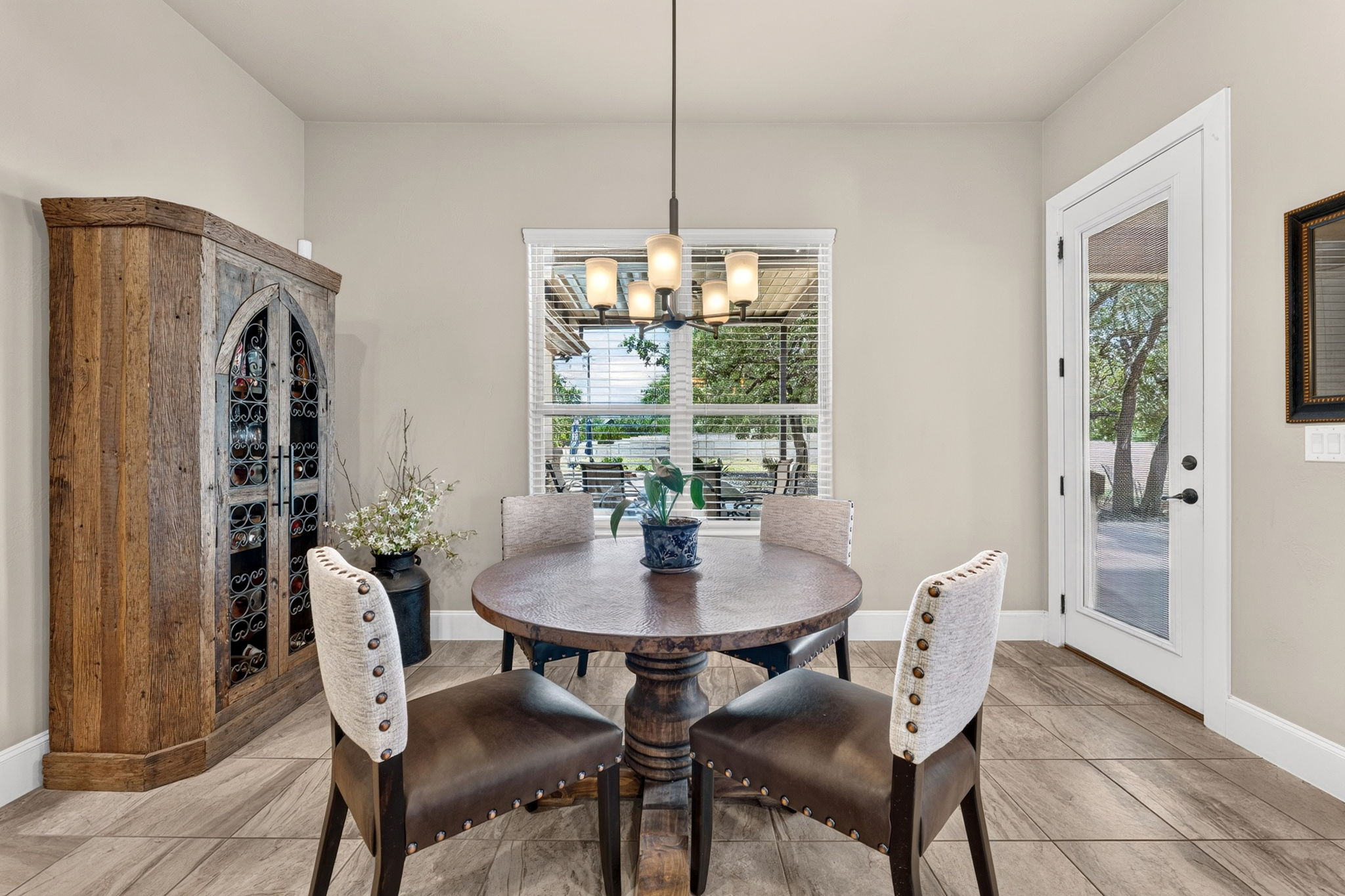 105 Coopers Hill Road Georgetown, TX 78633 - Photo 18 of 40 a dining room with furniture a chandelier and window
