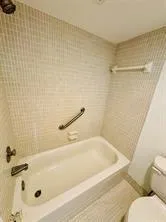 a bathroom with a tub and a shower