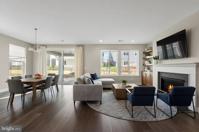 a living room with furniture dining table and a fireplace