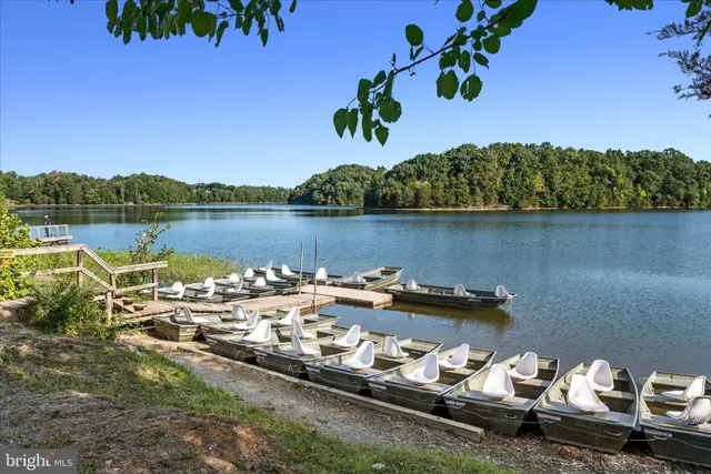 a view of a lake with boats and trees all around