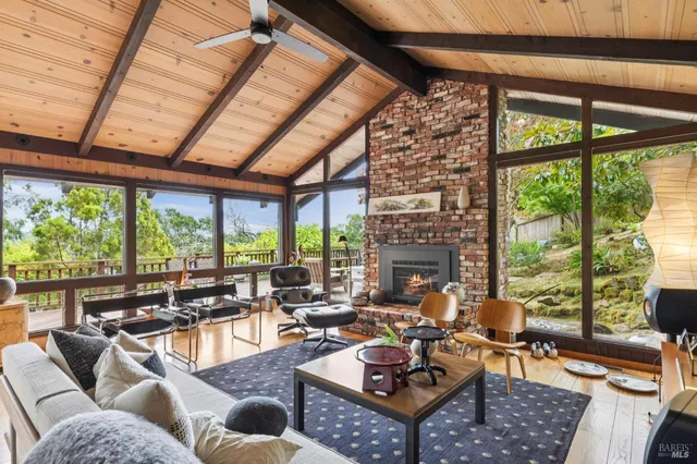 a living room with furniture and a floor to ceiling window
