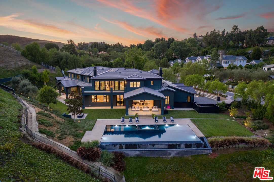 an aerial view of a house with a big yard