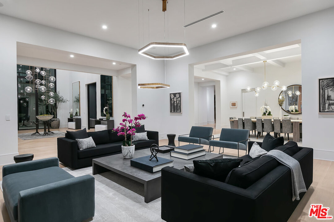 25211 Jim Bridger Road Hidden Hills, CA 91302 - Photo 11 of 42 a living room with furniture kitchen and a chandelier