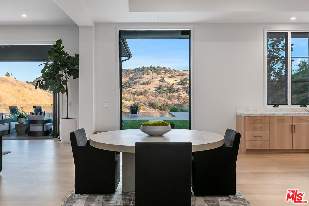 25211 Jim Bridger Road Hidden Hills, CA 91302 - Photo 17 of 42 a view of a dining room with furniture window and outside view