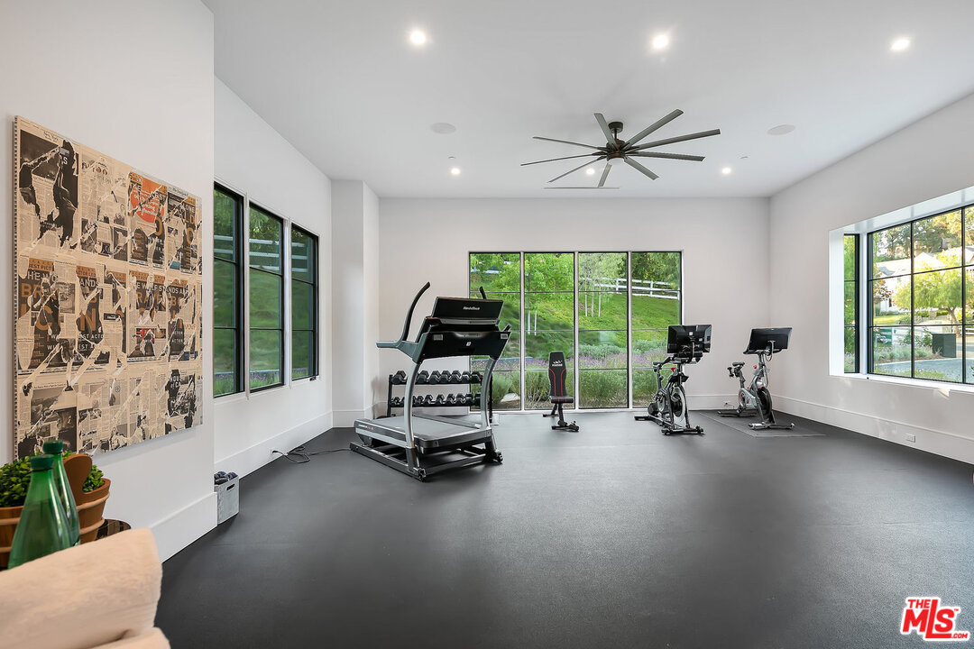 25211 Jim Bridger Road Hidden Hills, CA 91302 - Photo 22 of 42 a living room with furniture and a large window