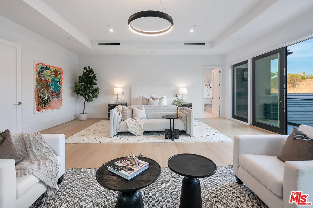 25211 Jim Bridger Road Hidden Hills, CA 91302 - Photo 26 of 42 a living room with furniture a rug and a large window