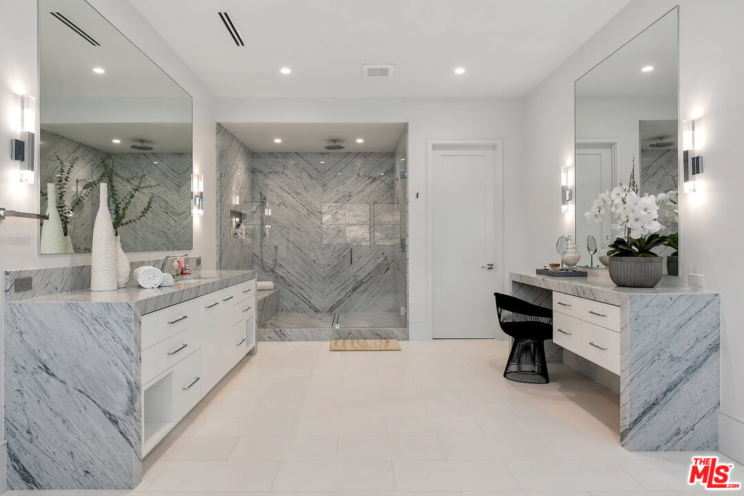 25211 Jim Bridger Road Hidden Hills, CA 91302 - Photo 27 of 42 a bathroom with a double vanity sink mirror and shower