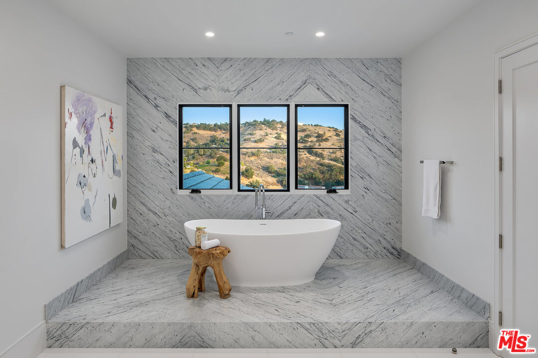 25211 Jim Bridger Road Hidden Hills, CA 91302 - Photo 28 of 42 a bathroom with a bathtub and a shower