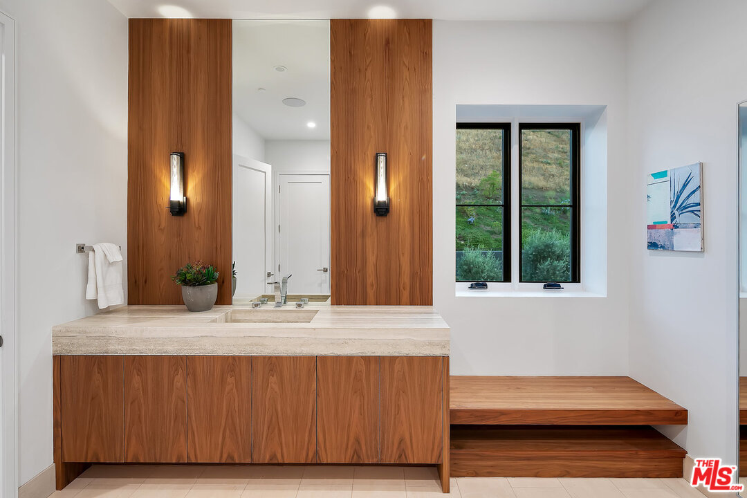 25211 Jim Bridger Road Hidden Hills, CA 91302 - Photo 31 of 42 a bathroom with a sink and a mirror