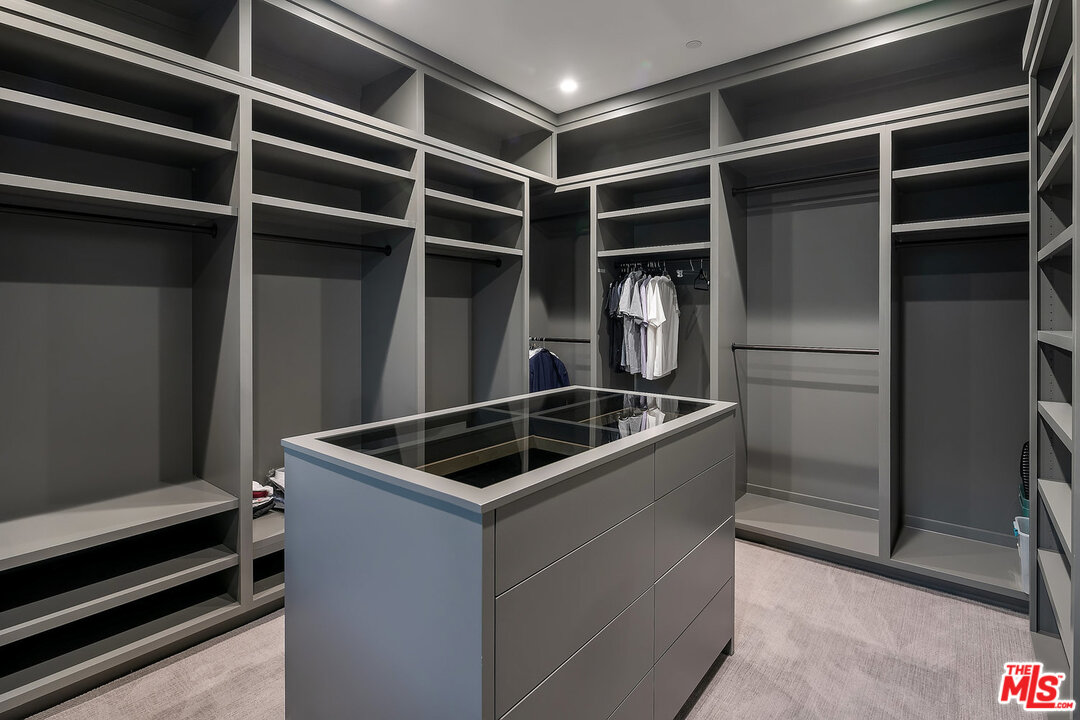 25211 Jim Bridger Road Hidden Hills, CA 91302 - Photo 33 of 42 a kitchen with a refrigerator and a sink