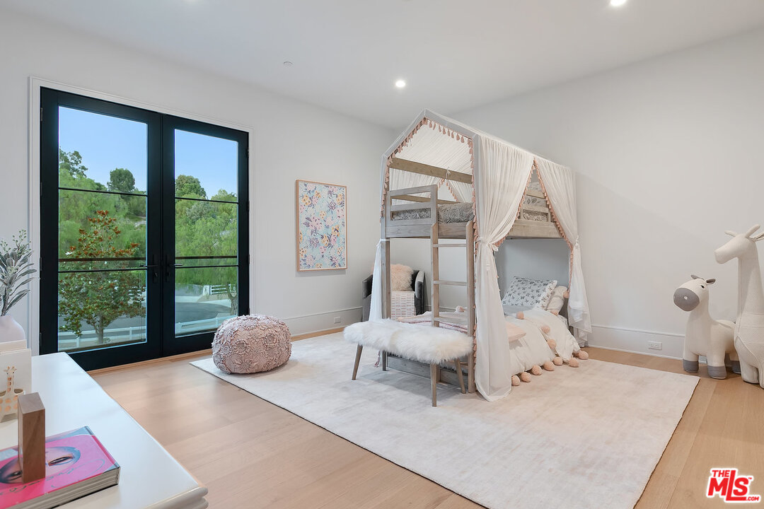 25211 Jim Bridger Road Hidden Hills, CA 91302 - Photo 36 of 42 a living room with furniture and a large window