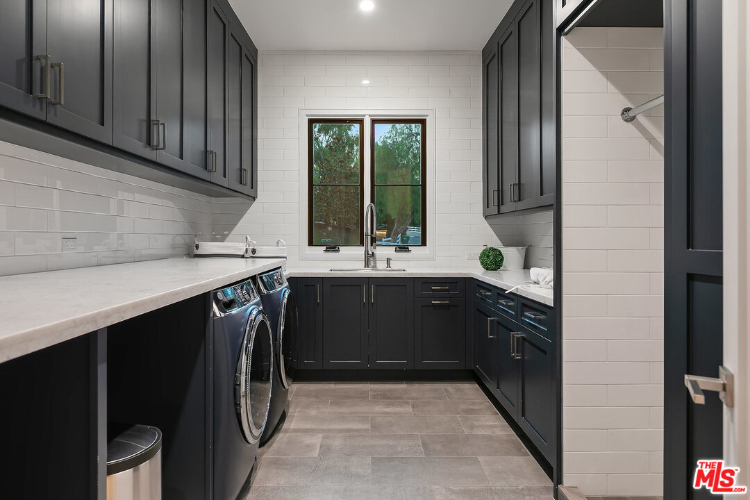 25211 Jim Bridger Road Hidden Hills, CA 91302 - Photo 38 of 42 a kitchen with a sink and a cabinets