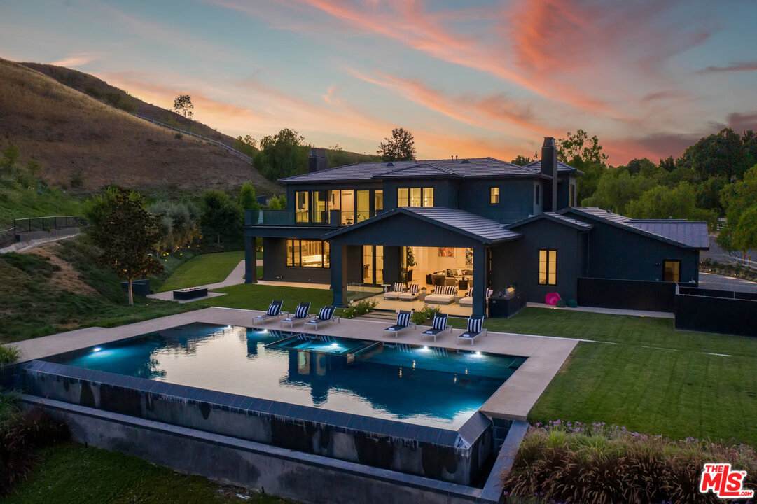 25211 Jim Bridger Road Hidden Hills, CA 91302 - Photo 40 of 42 a front view of a house with garden