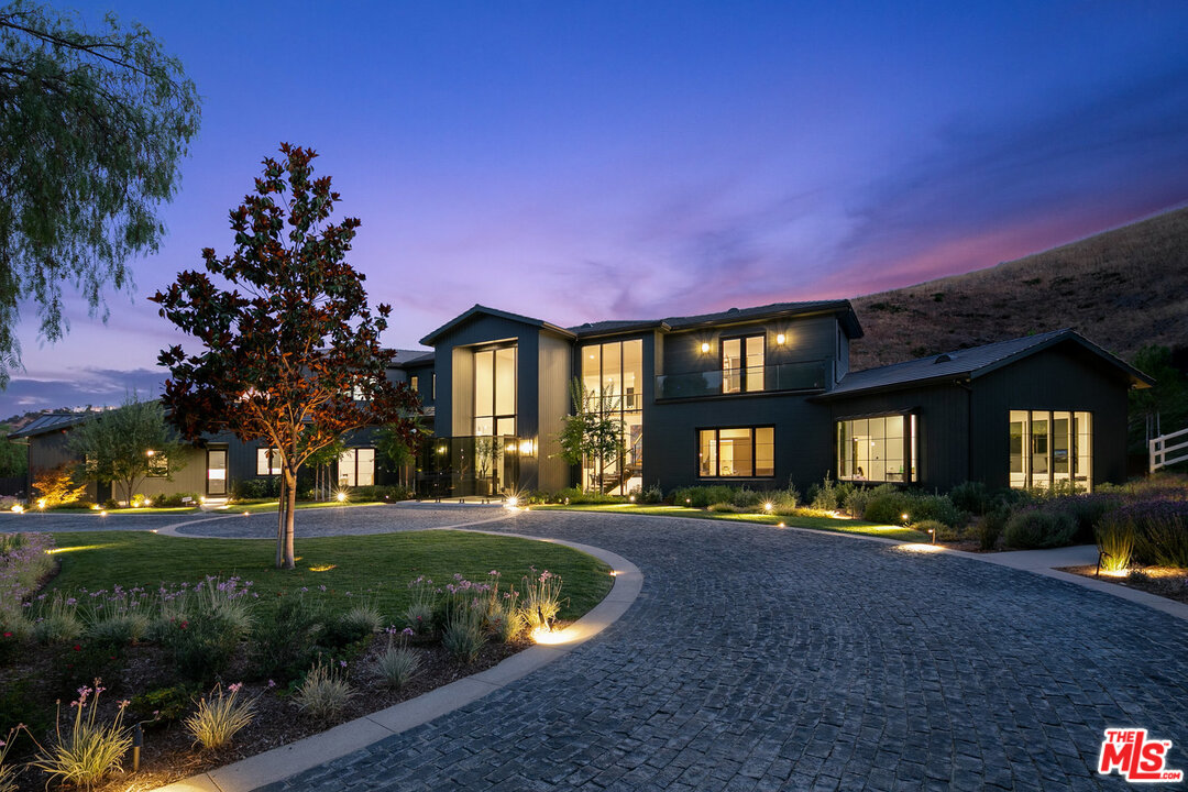 25211 Jim Bridger Road Hidden Hills, CA 91302 - Photo 5 of 42 a front view of a house with a yard
