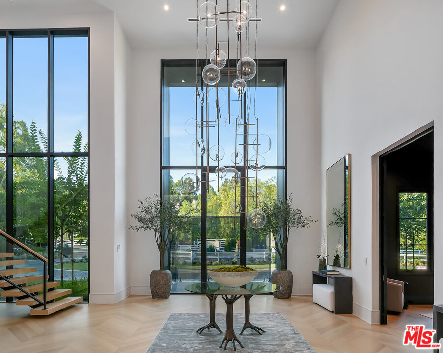 25211 Jim Bridger Road Hidden Hills, CA 91302 - Photo 7 of 42 a living room with furniture and a floor to ceiling window