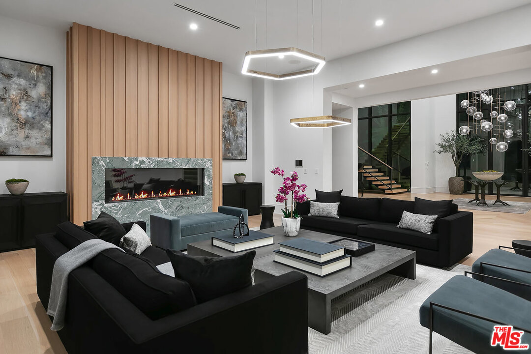 25211 Jim Bridger Road Hidden Hills, CA 91302 - Photo 10 of 42 a living room with furniture and a fireplace