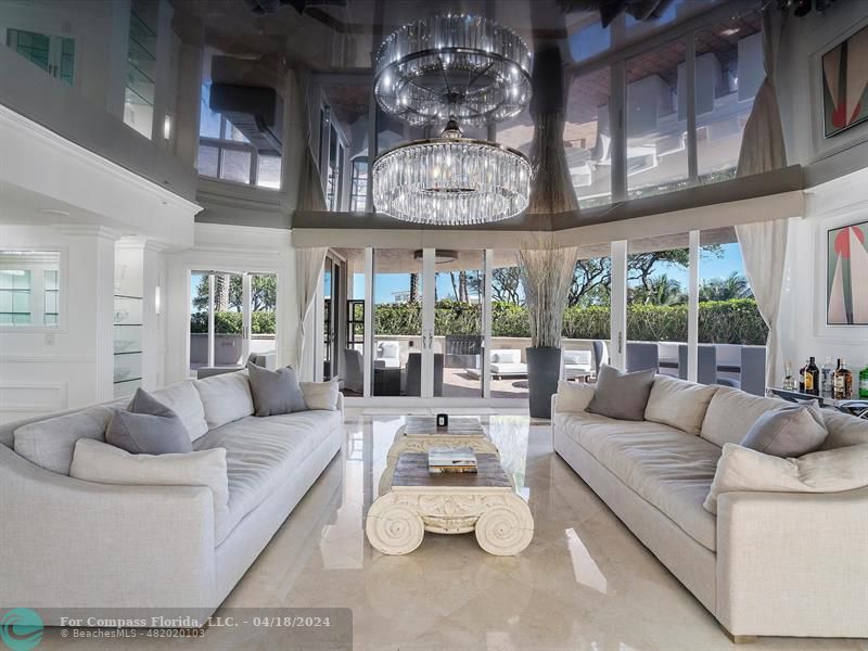 a living room with furniture and chandelier