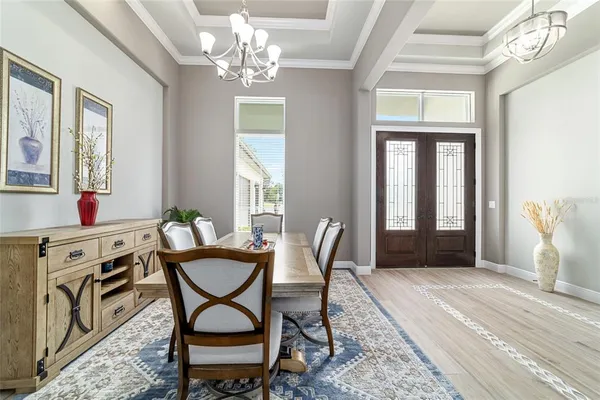 a kitchen with stainless steel appliances granite countertop a kitchen island a stove a table and chairs in it