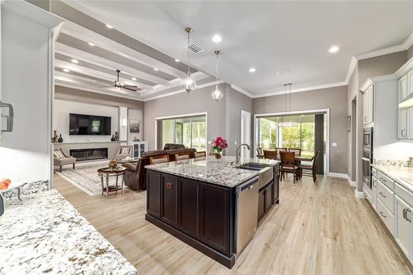 a dining room with furniture and large windows
