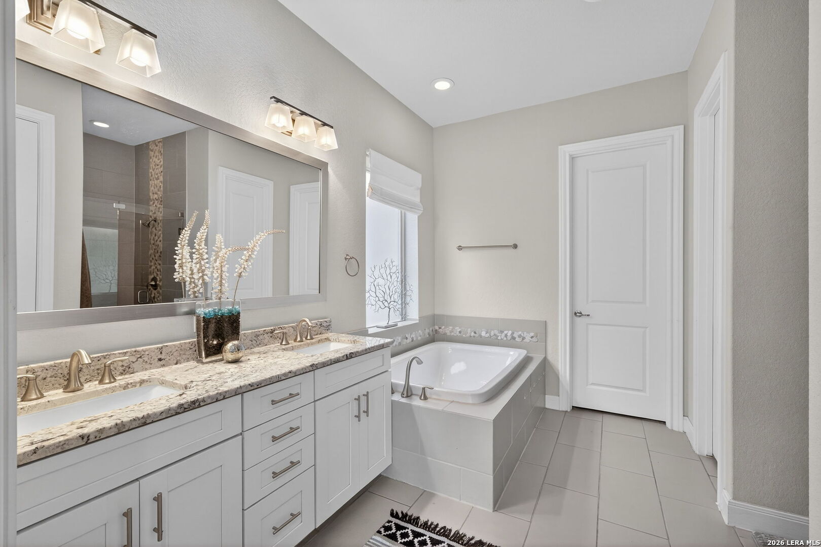 11202 Vance Jackson Road, Unit 17 San Antonio, TX 78230 - Photo 11 of 19 a bathroom with a granite countertop sink and a mirror
