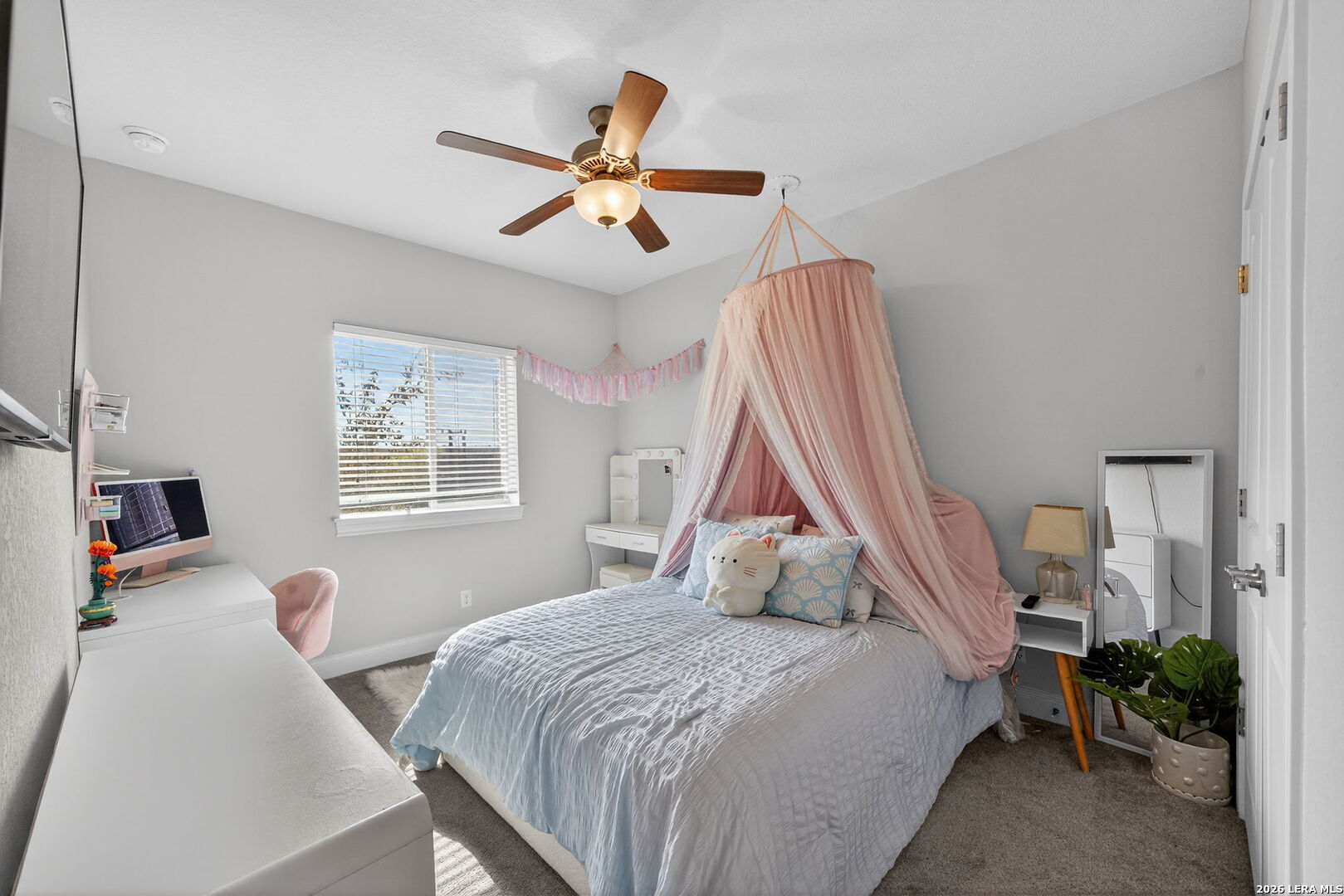 11202 Vance Jackson Road, Unit 17 San Antonio, TX 78230 - Photo 15 of 19 a bedroom with a bed and a chandelier