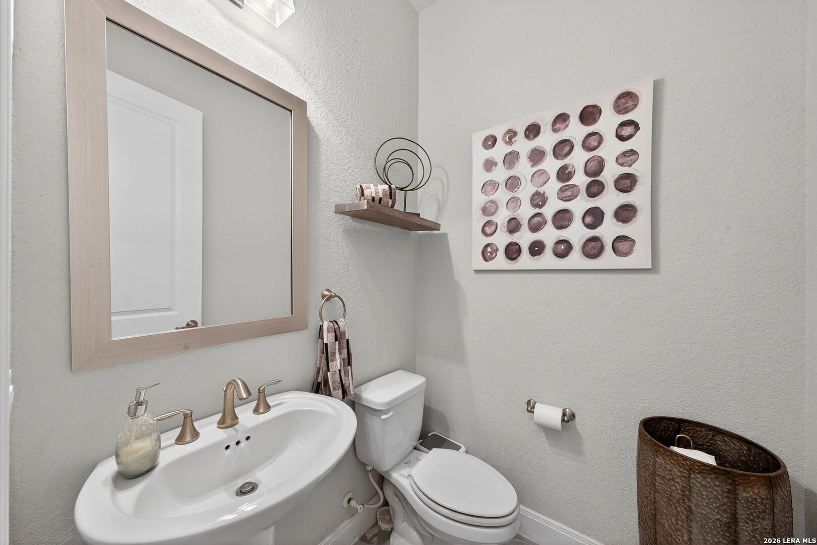 11202 Vance Jackson Road, Unit 17 San Antonio, TX 78230 - Photo 5 of 19 a bathroom with a toilet sink and mirror